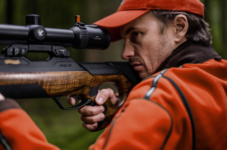 Rifle Walther RS3 con visor montado en manos de cazador profesional en el bosque